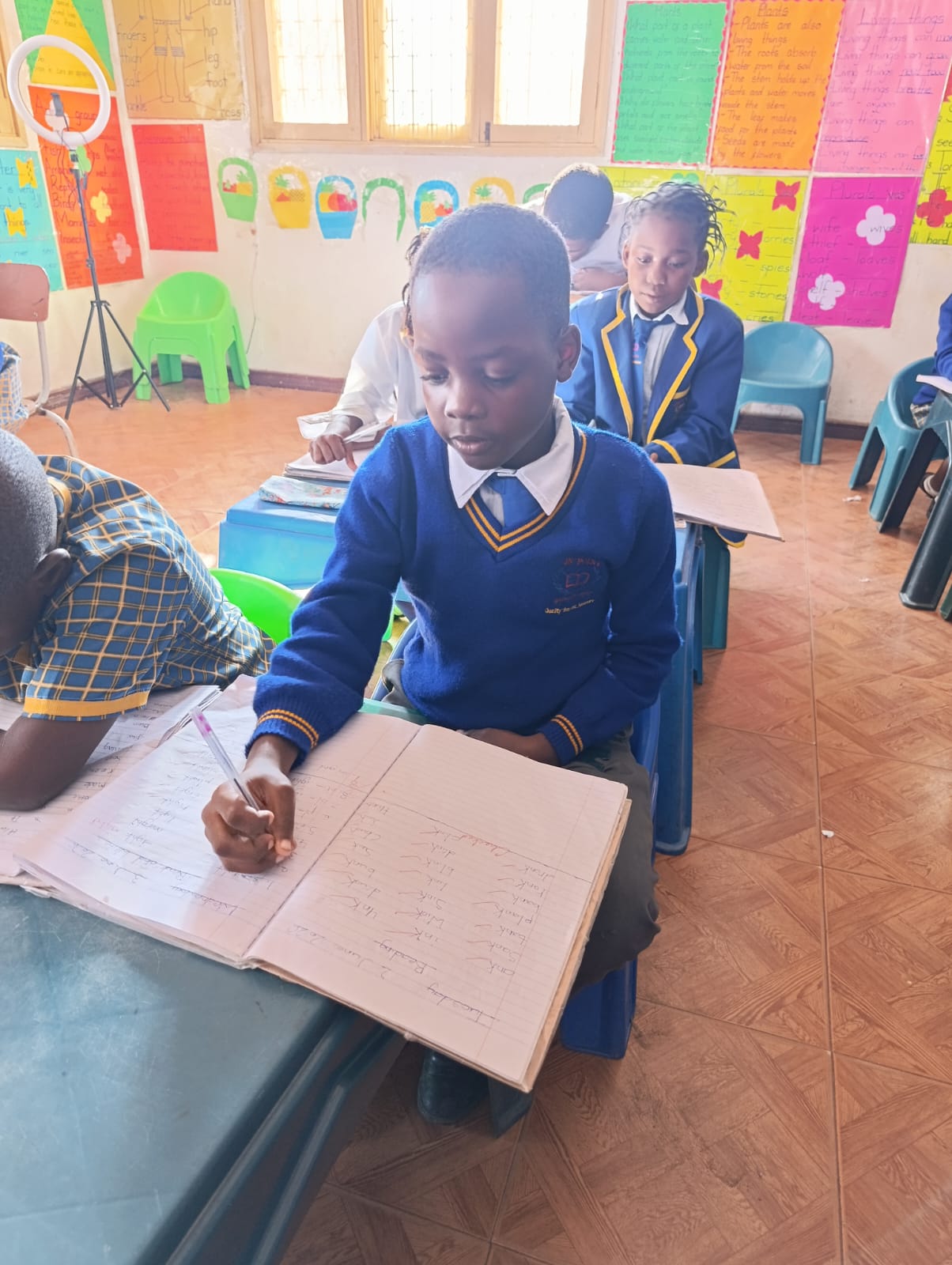 A student writing during a lesson at On Point Education Centre